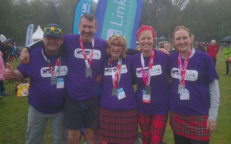 Carers Link team brave a wet and windy Kiltwalk Kiltwalkers celebrate completing the walk